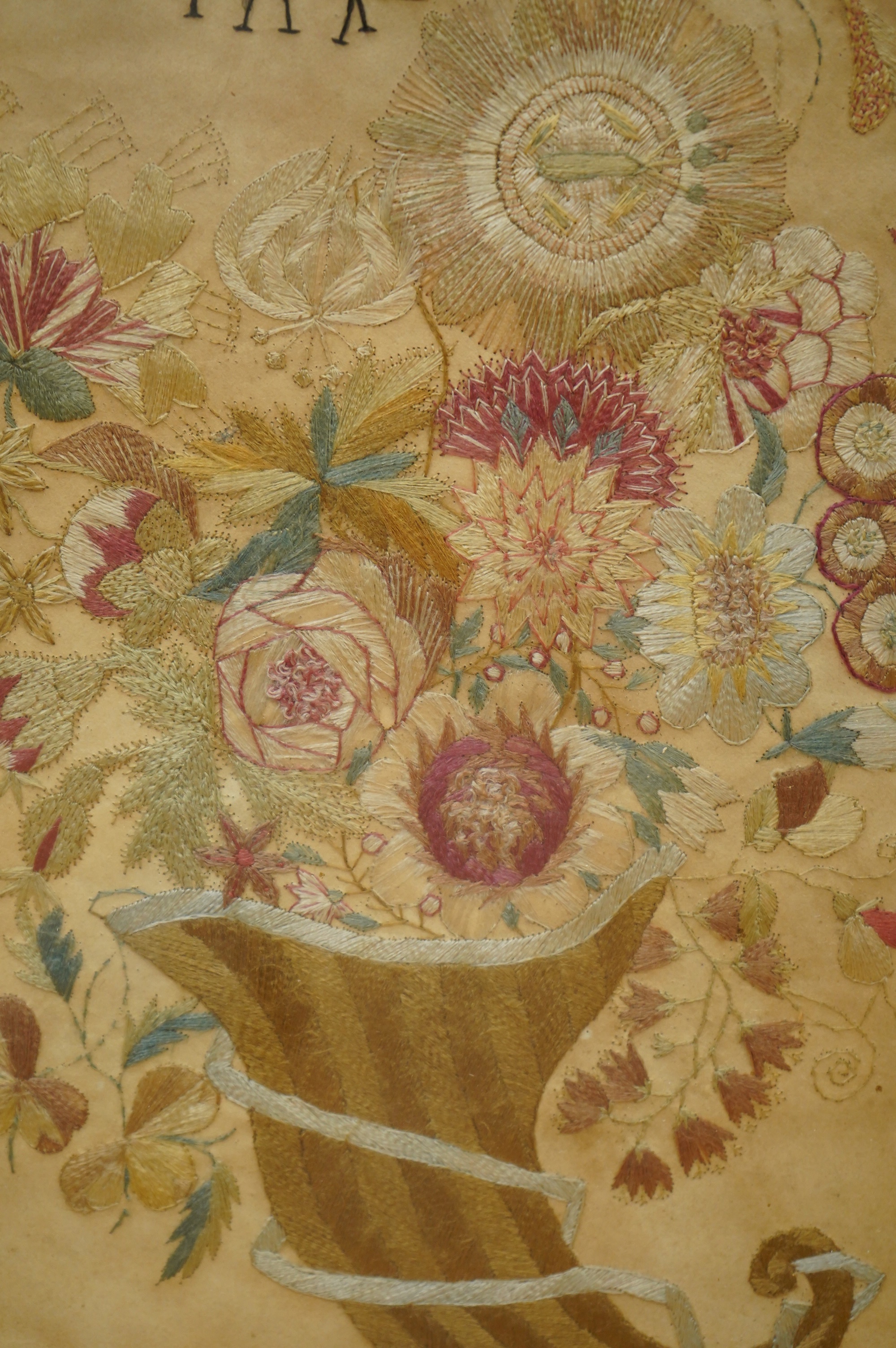 A late 18th century polychrome floral silk work embroidery of a cornucopia of flowers and a butterfly above, dated 1770, together with an early 19th century embroidery of a spray of roses surrounded by a floral border, w